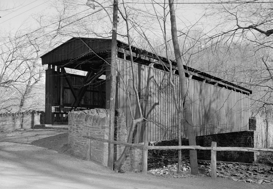 historic black and white photograph of a covered bridge